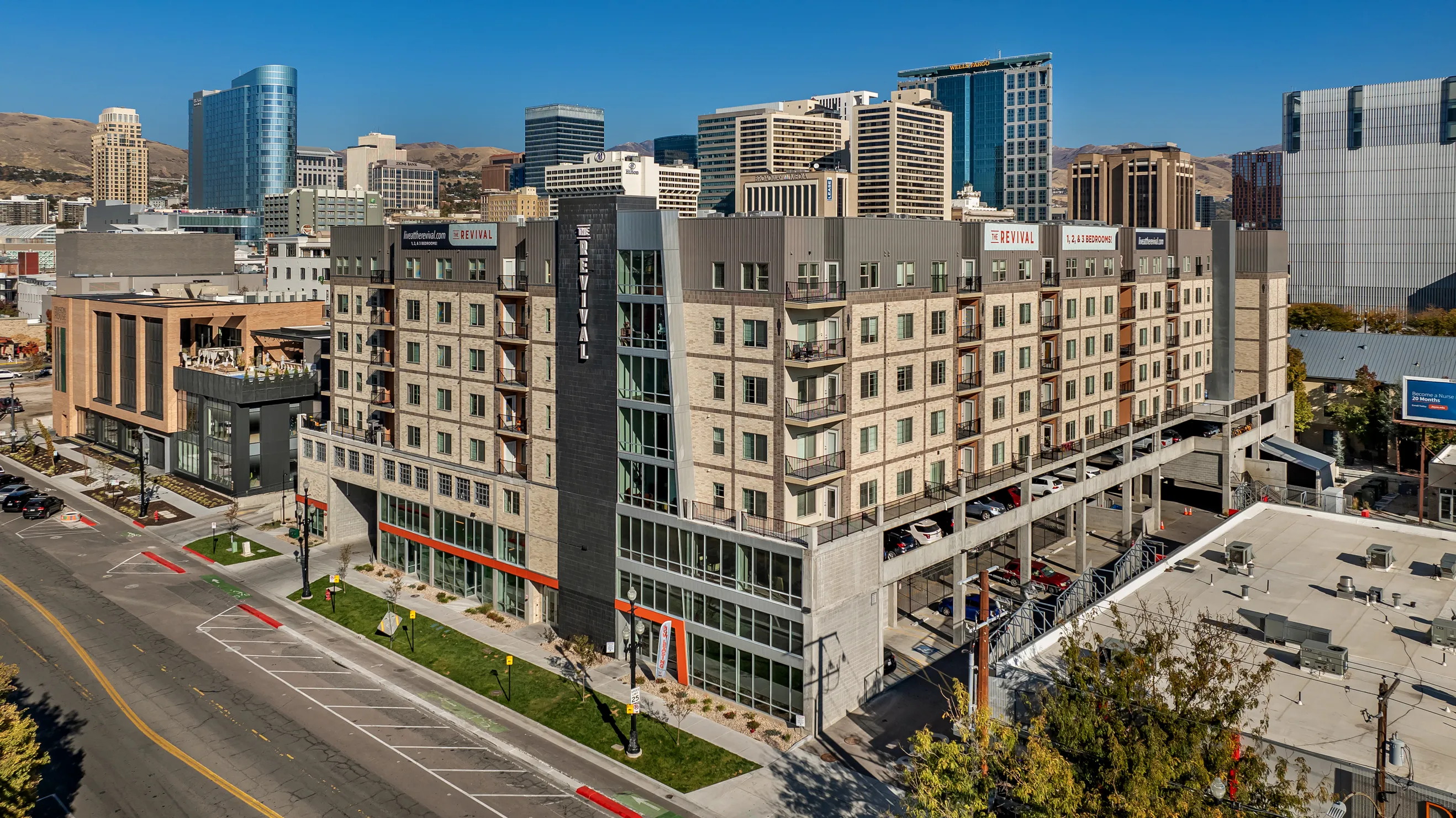 Dark brick accents create contrast and hierarchy in multifamily design.