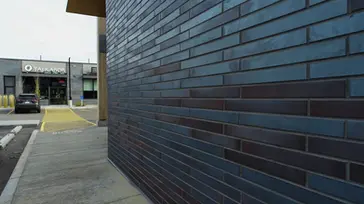 Close-up detail of Obsidian Shadow thin brick with subtle color variation and smooth texture.