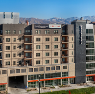 Mixed-use apartment building in Utah featuring Manganese thin brick on the facade, showcasing a modern masonry design with dark accent panels and light brick tones.