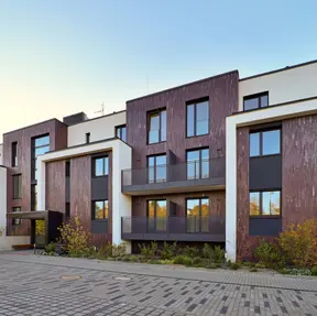 Modern apartment building with contrasting brick and light façades