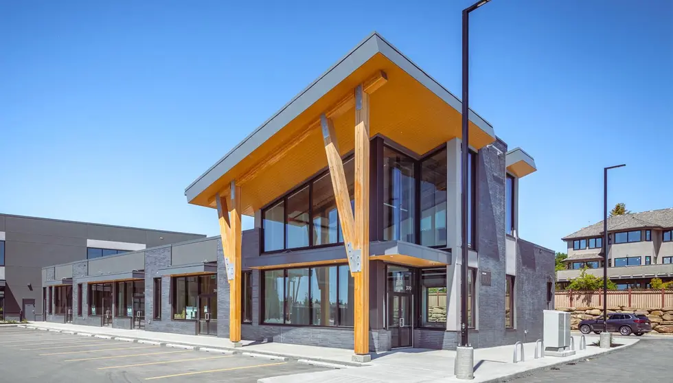 Christie Crossing in Calgary features Obsidian Shadow thin brick in Imperial size with dramatic wood columns and a modern roofline.