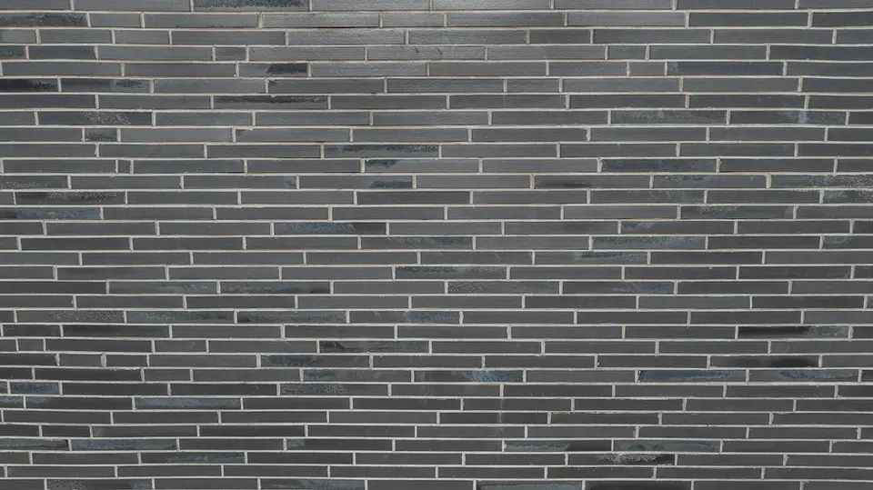 Close-up of Black Beauty thin brick in American Imperial size, showing elongated gray brick units with subtle color variation and clean horizontal coursing.