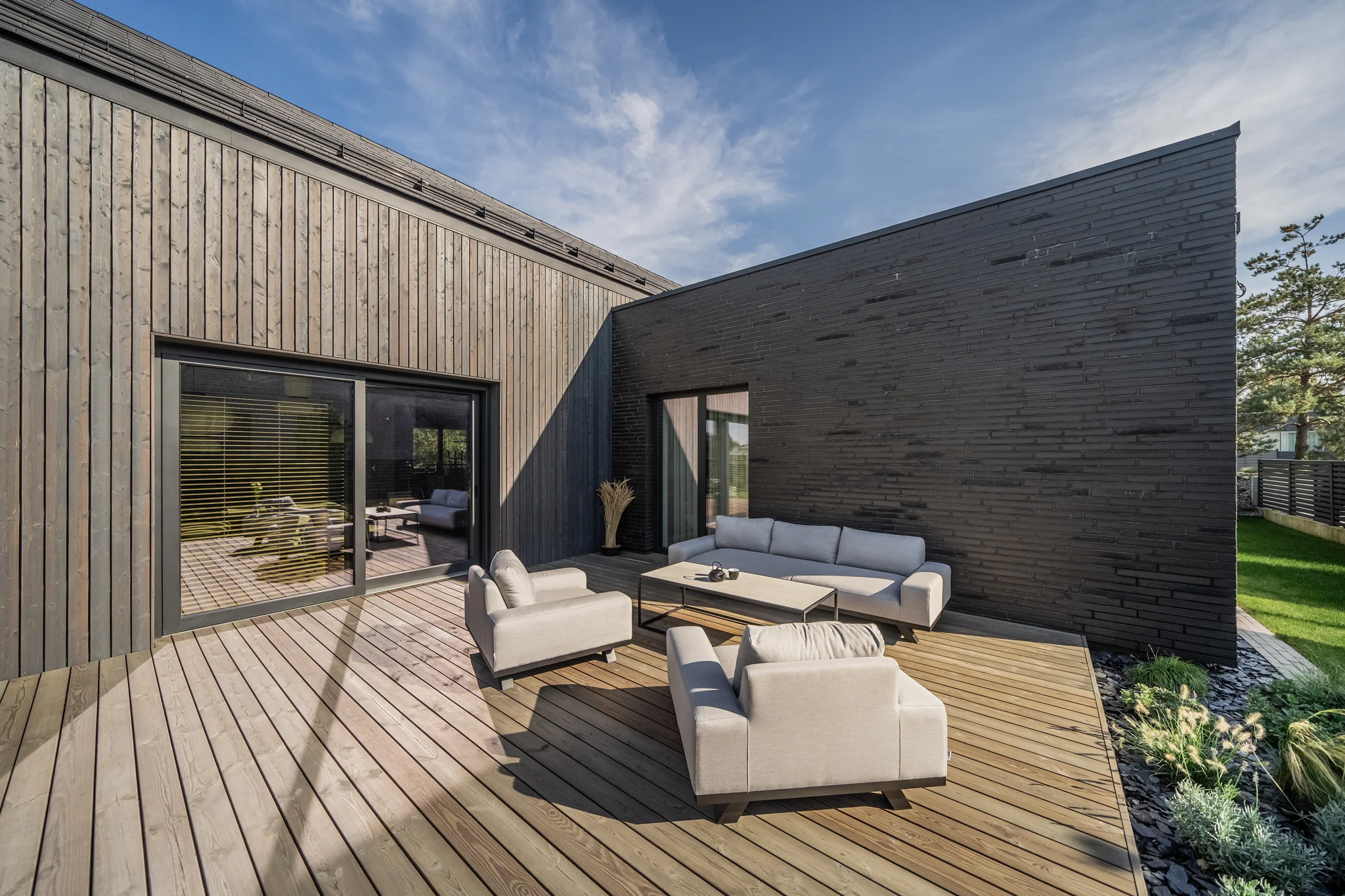 Dark brick and wood create a warm, contemporary outdoor living space.