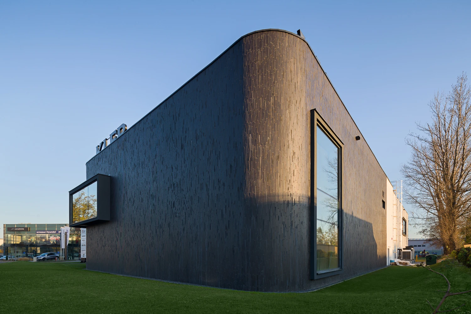 Dark thin brick and glass create a bold modern exterior.