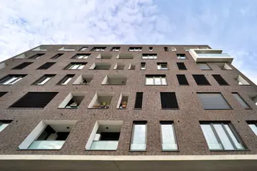 Low-angle view of Blues Shadow thin brick emphasizing clean lines, dimensional depth, and modern masonry detailing.