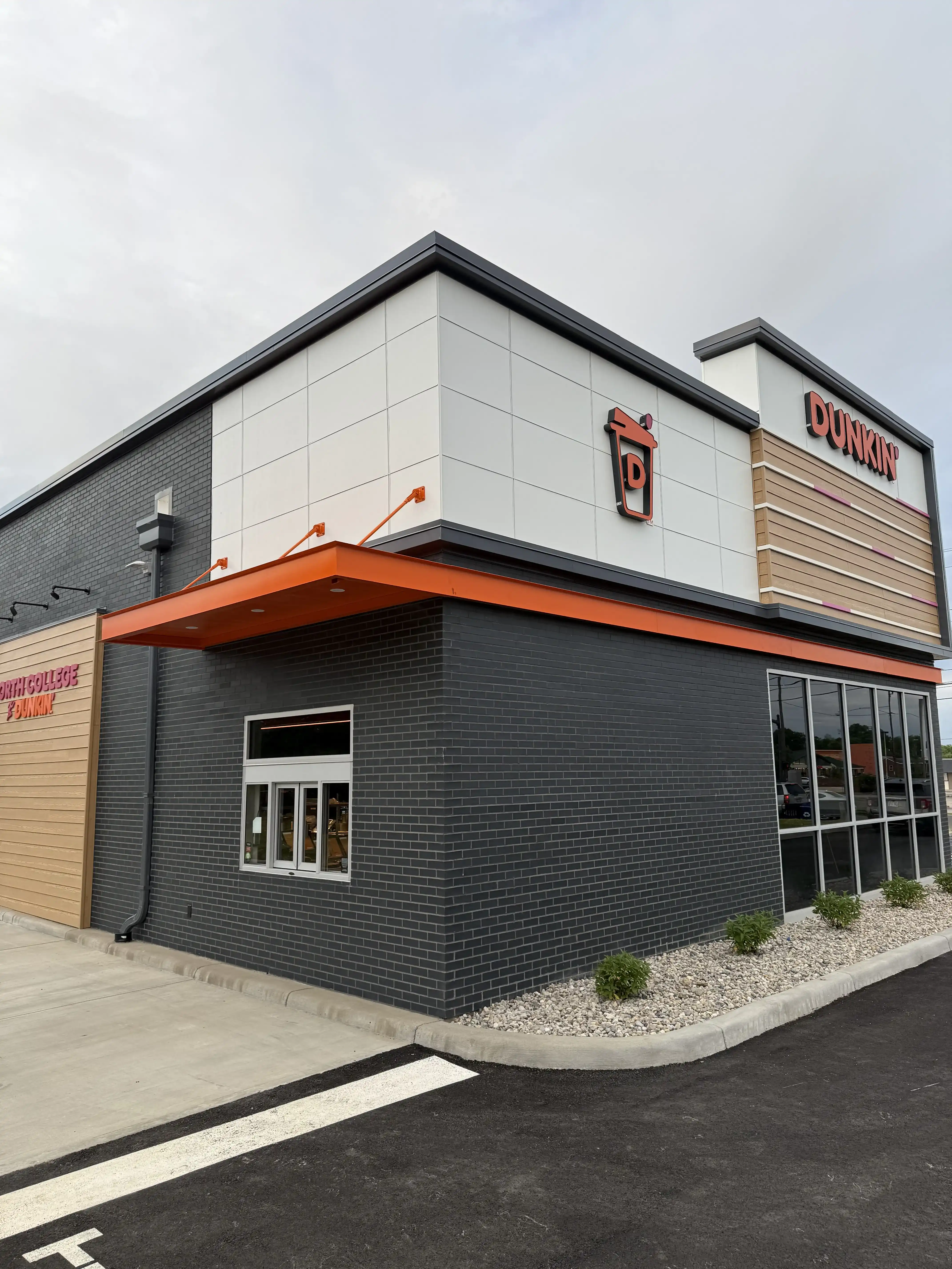 Dark brick helps Dunkin' signage stand out with strong visual contrast.