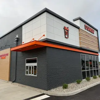 Dark brick helps Dunkin' signage stand out with strong visual contrast.