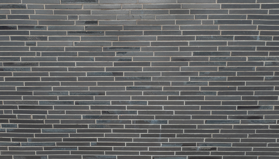 Black Beauty thin brick in imperial size was chosen to cover the facade of this medical office building where RPT, Registered Physical Therapists, Vitae Chiropractice and Family First Pediatric Dentisty and Orthodontics reside in West Jordan, Utah. Photo of wall up close to show thin brick. 
