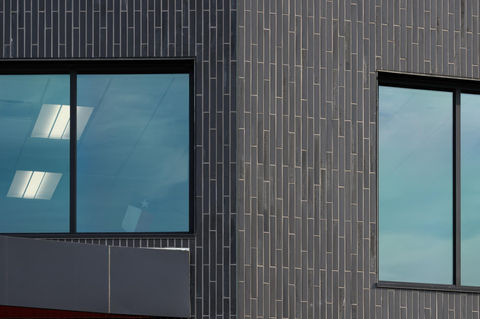 Detail view of Black Beauty thin brick in American Imperial size by Acme, showing clean masonry transitions around window frames at Dorothy Martinez Elementary School.