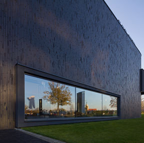 Black Beauty thin brick in imperial size on the facade of the Kler building in Katowice, Poland window reflection 