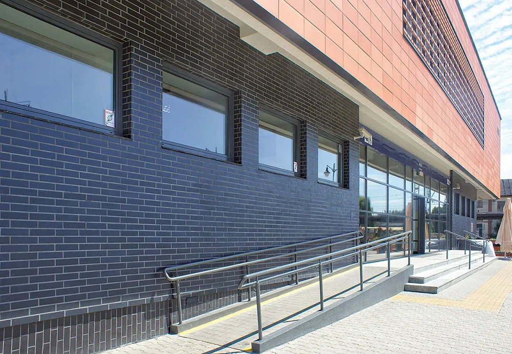 Dark brick creates a durable base for contemporary residential design.