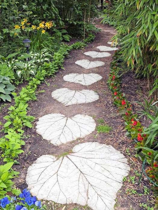 Leaf-shaped stepping stones path through lush garden