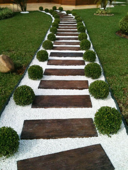 Curving garden path with wooden steps and white gravel