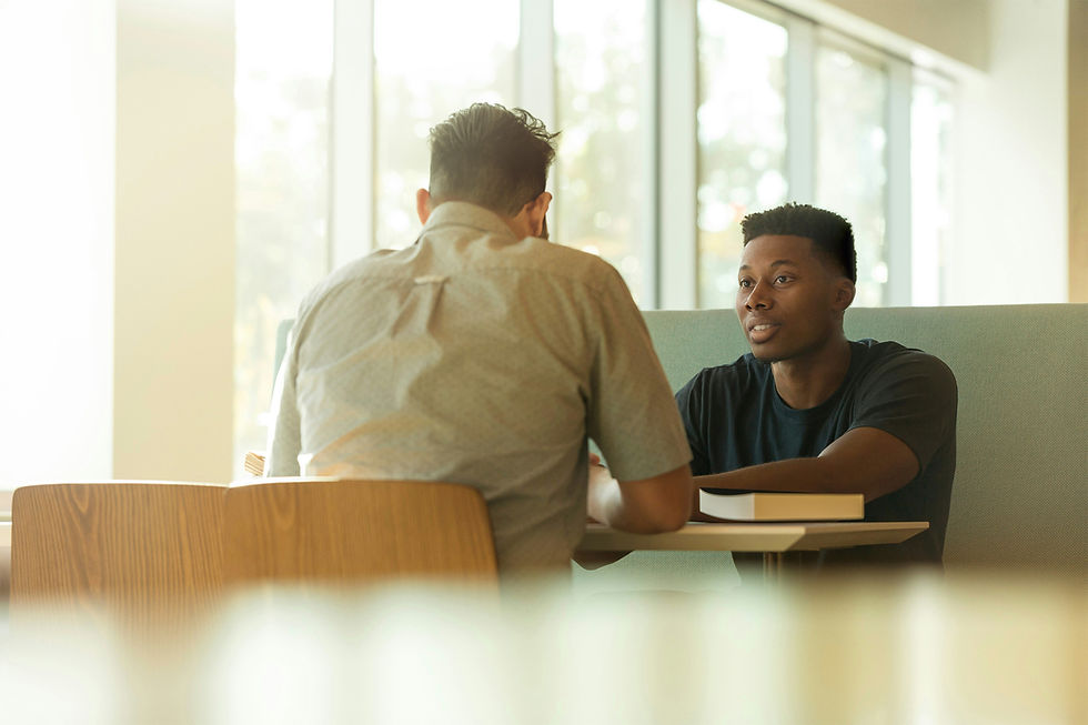 Two men studying the bible in a coffee shop