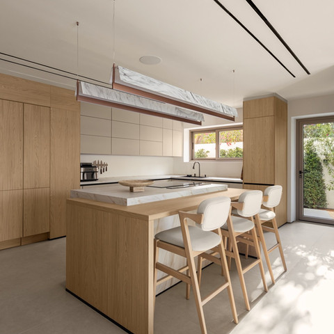 Modern luxury kitchen with island overlooking the outdoor landscape in Dubai
