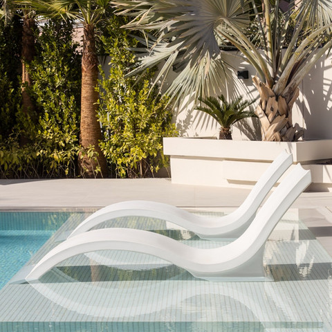 Luxury poolside sun loungers beside a modern swimming pool in ÉLEVÉ Villa, Arabian Ranches Dubai