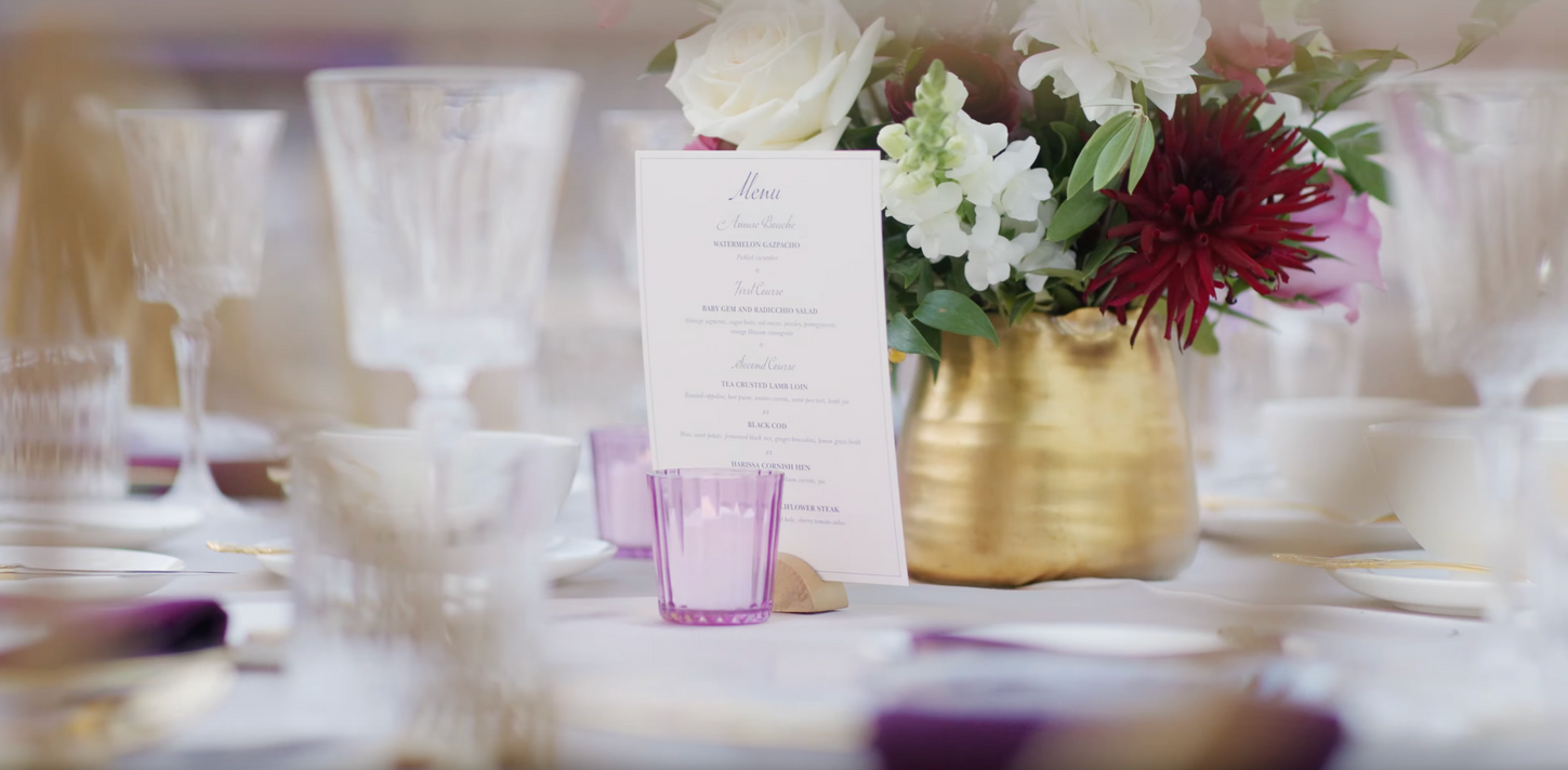 Elegant table setting with flowers and a custom-designed menu at the Lapis Gala.