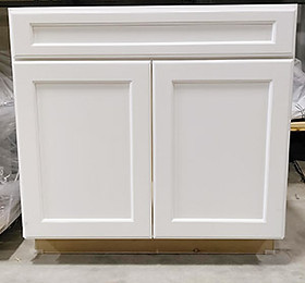 White, double door sink base on Clearance at Bernard Building Center's Hale store.