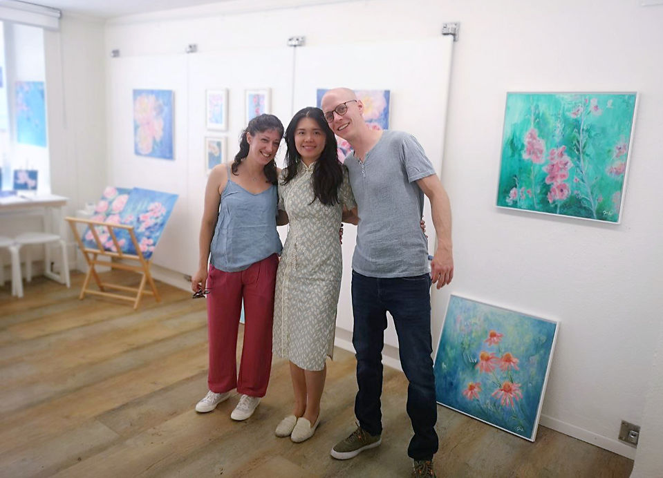 Artist Jenni Tan with friends, smiling for a photo