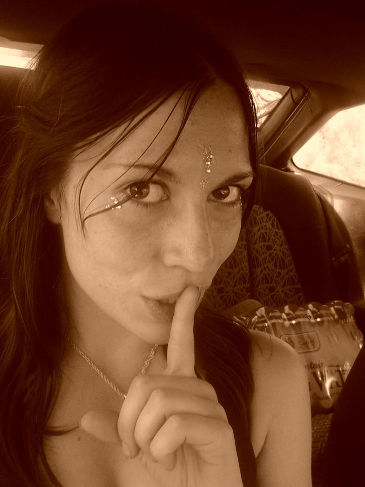 Picture of a pretty woman making the "shh" gesture of a finger to her lips