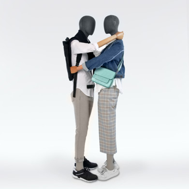 Future mannequins covered in grey fabric and wooden arms