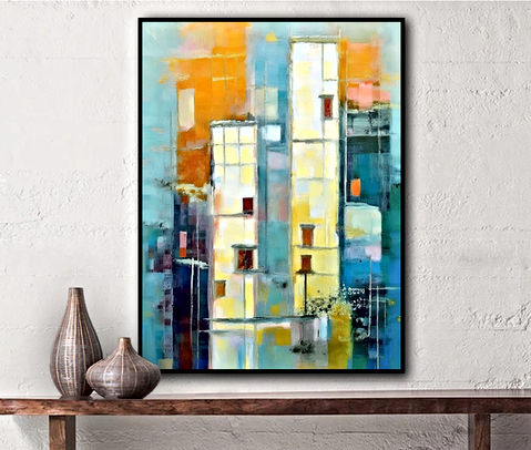 The image shows an abstract painting with vertical rectangular blocks in shades of orange, yellow, white, and blue, resembling buildings. The background has splashes of blue and white, suggesting sky or water reflection.