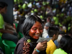 Indigenous woman reading and smiling