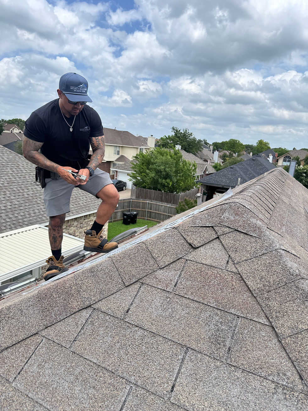 Legacy Builders roofer installing shingles on a roof ridge in North Texas
