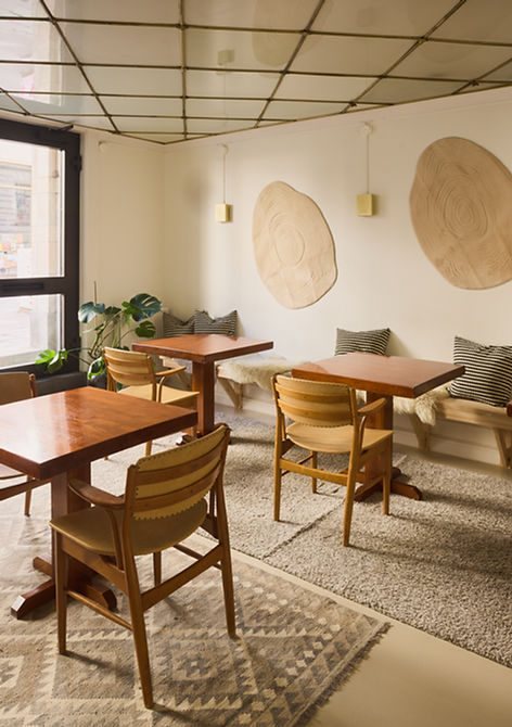 Cafét set up with café tables by the street-facing window, Södermalm Stockholm