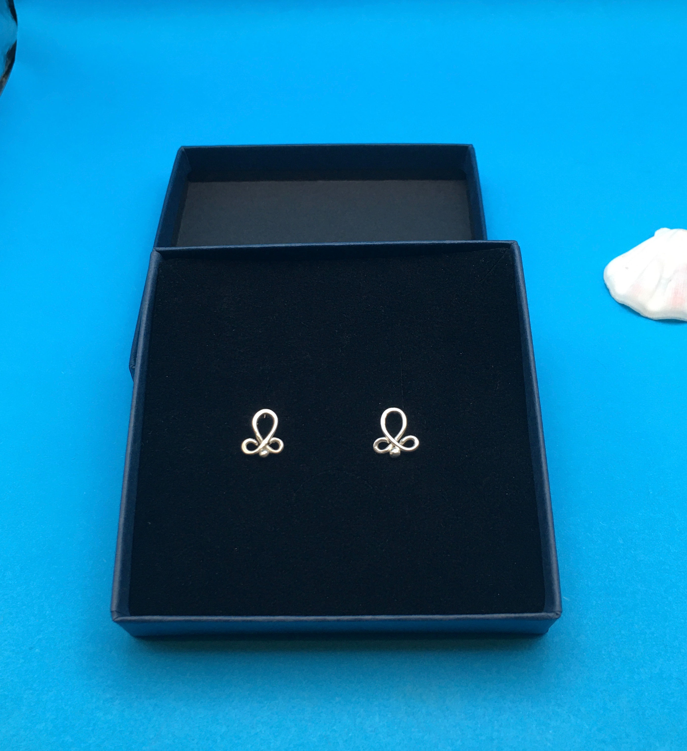 Fleur de Lys stud-style earrings 