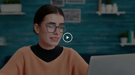 Woman with glasses working on laptop
