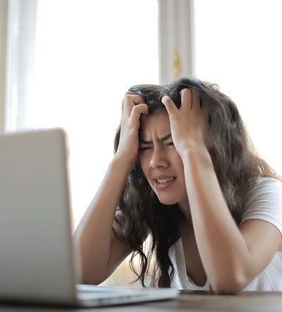 Woman getting stressed infront of her laptop