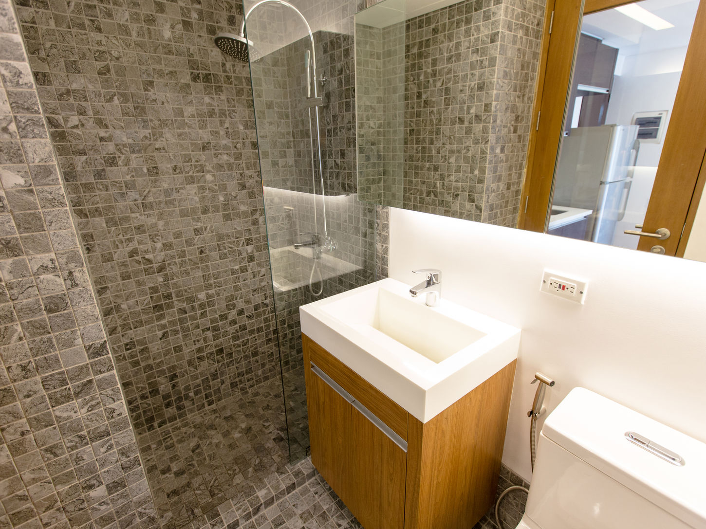 Modern bathroom with shower, sink, and toilet