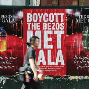 Source: Getty Images. Boycott the Bezos Met Gala wheatpasted in NYC May 2026