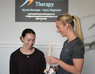 Physio talking spine to a client