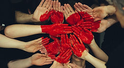 many hands using their piece of red to make a heart