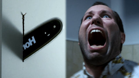 On one side of the image is a chainsaw cutting through a door. On the other side is a man in a bathroom screaming.