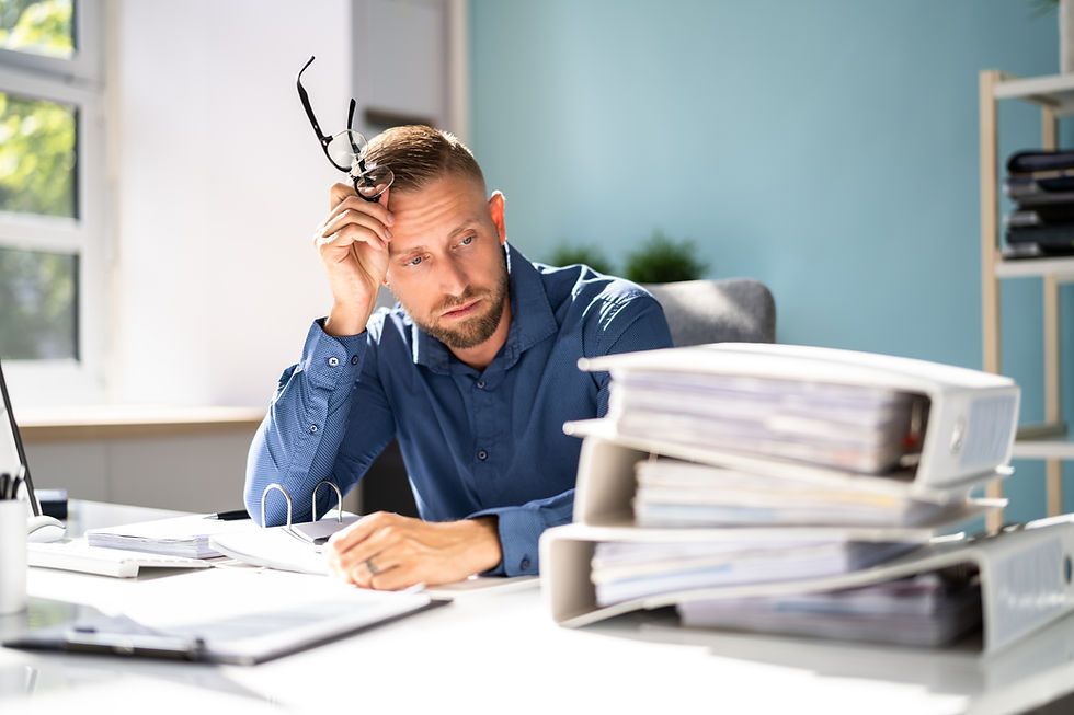 A stressed employee showing signs of fatigue and physical strain, representing the early stages of health decline.