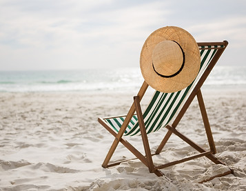 straw-hat-kept-empty-beach-chair.jpg