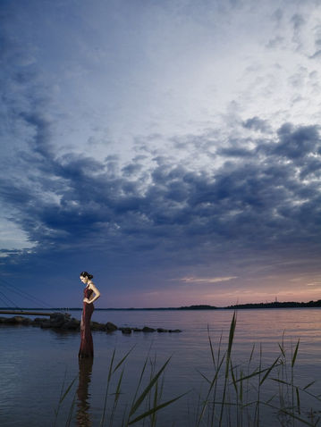 an elegant  model walking on a sweden lake