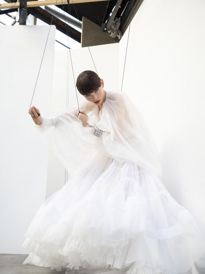 a model with wire everywhere,  looking to you like a puppet who want to be free