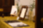 Them Poems open guest book positioned next to a framed poem and flowers