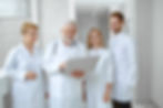 Image of a diverse medical team looking at a laptop, suggesting a supportive environment for new members.