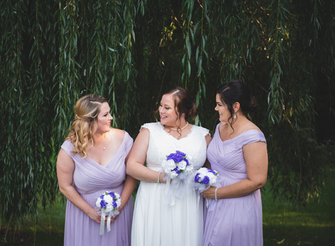 bride and bridesmaids standing together