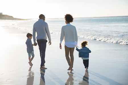 Healthy family walks together along the beach