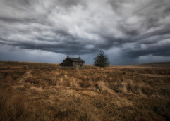 Heavy storms head toward the abandoned farmhouse at Nun's Cross, Dartmoor