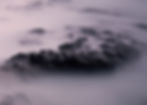 Dark rocky outcrops rise through pale fog in a moody lavender seascape, with faint watermark text Thorn Valley Studios.