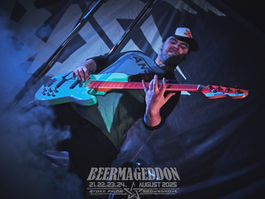 Man playing a blue bass on a smoky stage; poster text reads BEERMAGEDDON, 21st-24th August 2025, Stoke Prior, Bromsgrove