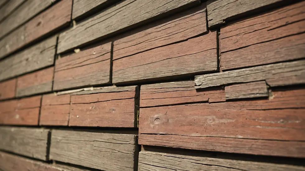 Close-up view of exterior paint on wooden siding showing paint texture
