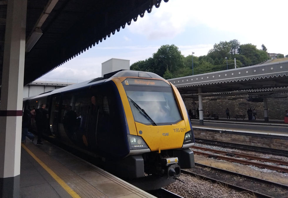 A train sitting in a station, with the word "Nottingham"  in lights on the front.